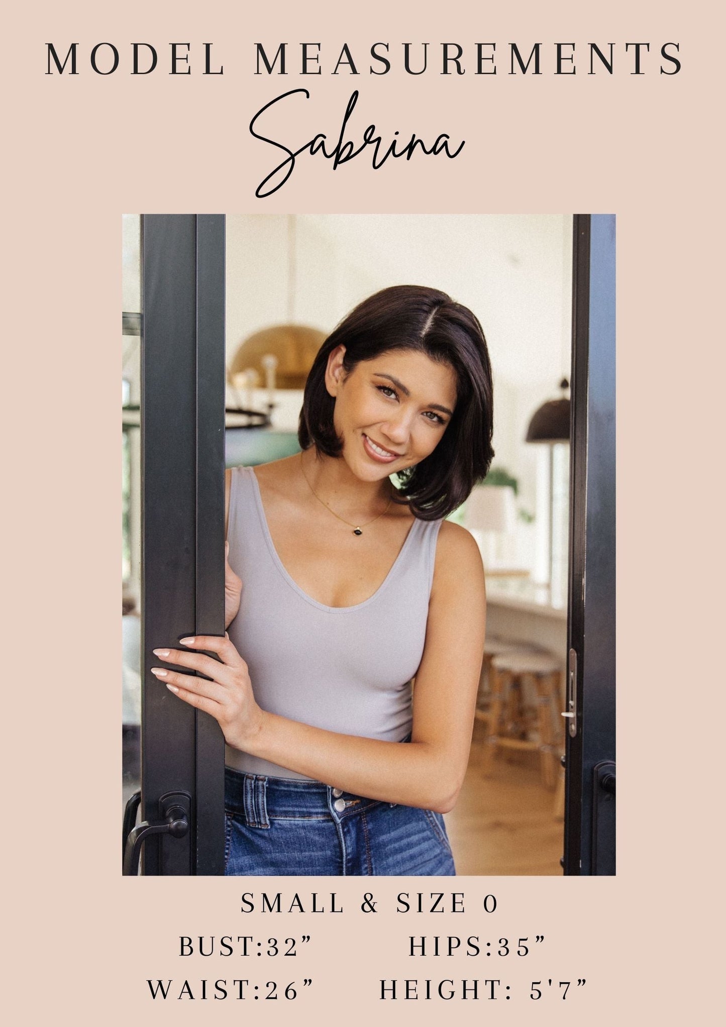 Tea-Shirt Shoppe model Sabrina wearing a light grey sleeveless top in a bright home interior setting