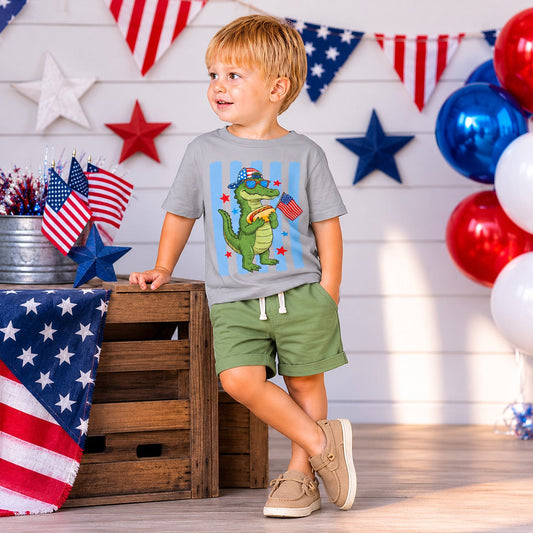 Tea Shirt Shoppe Wholesale grey 100% cotton graphic tee with a cartoon alligator wearing sunglasses and holding a hot dog and American flag.