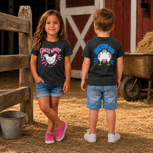 Tea Shirt Shoppe Wholesale youth and toddler graphic tee, 100% cotton, dark heather grey with chicken graphic and "Guess What?" text.
