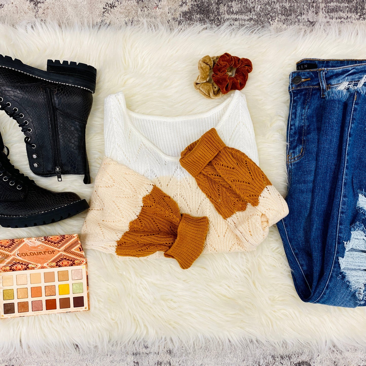 flatlay pic of outfit inspo with our color block knit sweater