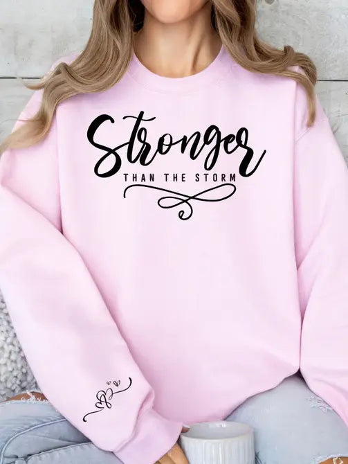 Stronger Than The Storm Graphic Sweatshirt Sweatshirt Tea Shirt Shoppe Small Lt. Pink