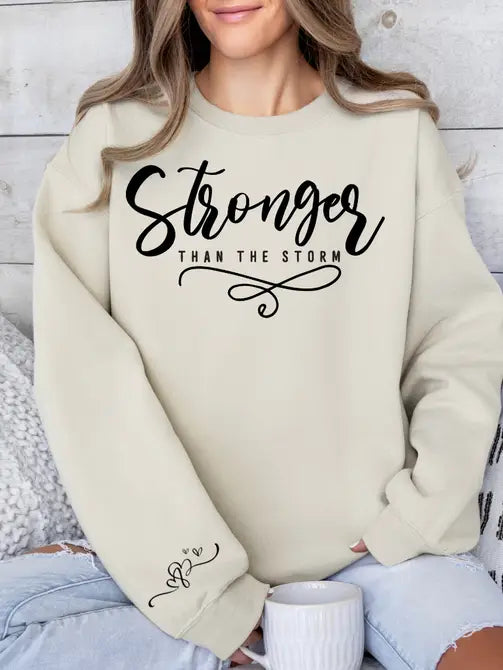 Stronger Than The Storm Graphic Sweatshirt Sweatshirt Tea Shirt Shoppe Small Sand