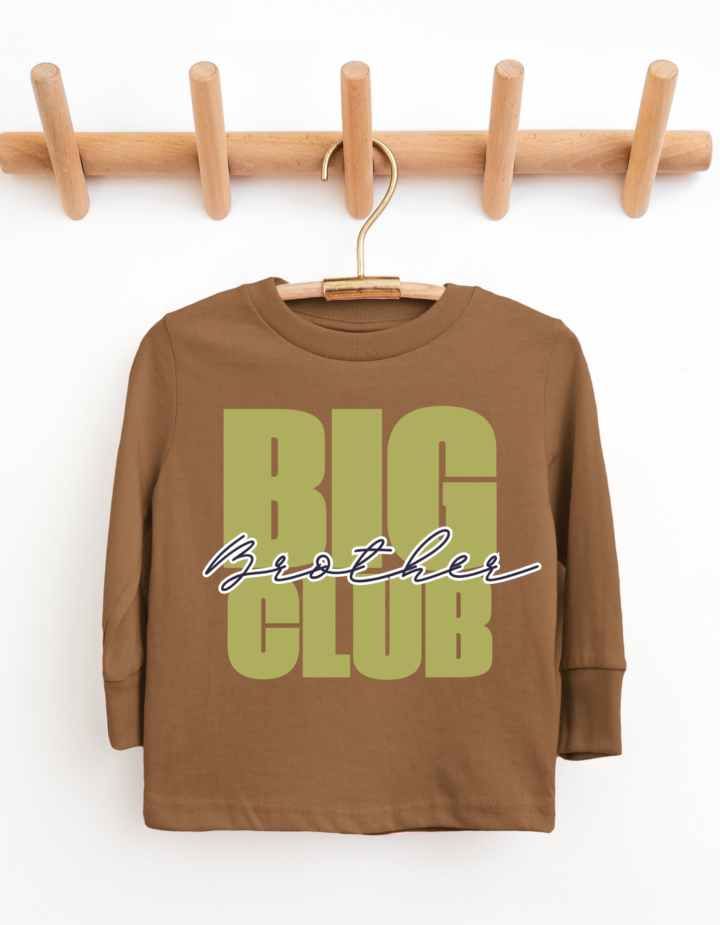 Brown long-sleeve shirt with 'BIG Brother CLUB' text on a wooden hanger against a white background