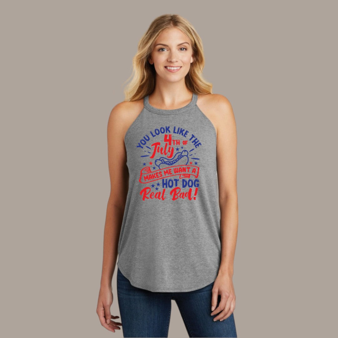 A woman in a heather grey tank top with a playful message for the 4th of July, featuring red and blue text and hot dog graphics