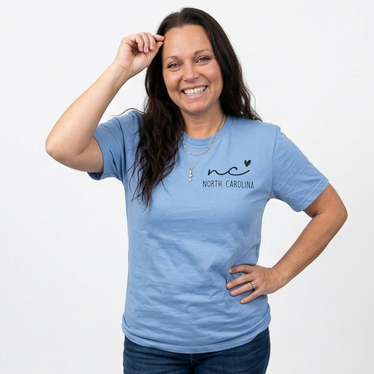 Woman wearing a blue t-shirt with a logo and text, standing against a white background