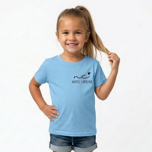 Young girl wearing a light blue t-shirt with 'North Carolina' design on a white background