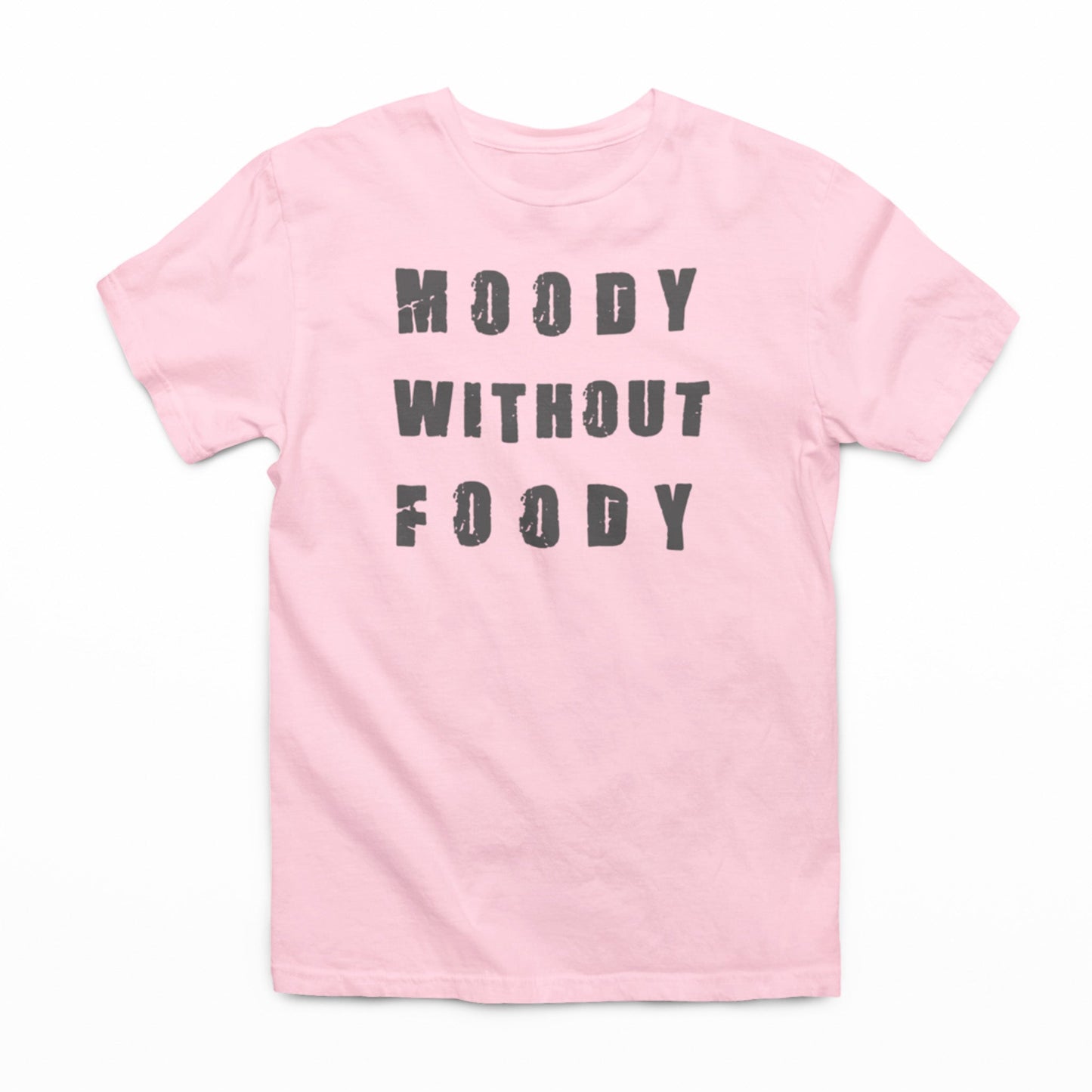 "A pink t-shirt laid out on a white background, featuring the phrase 'MOODY WITHOUT FOODY' in large, grey, distressed font. The shirt is unadorned otherwise, with a crew neckline and short sleeves, emphasizing the message as the focal point."