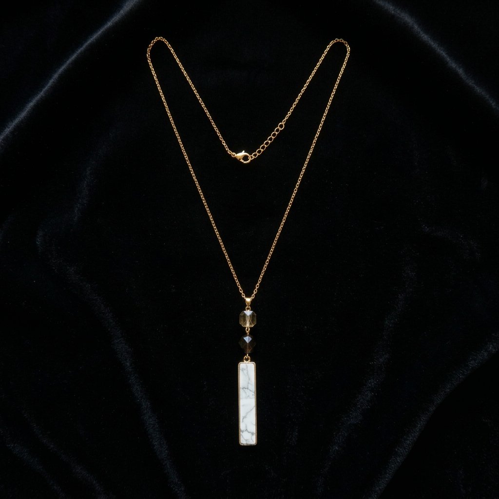 Gold necklace with a pendant on a black velvet background