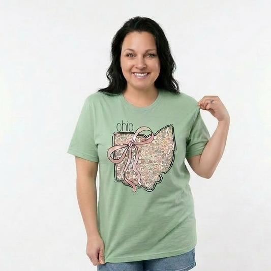 Woman wearing a green Ohio t-shirt with a graphic design on a white background