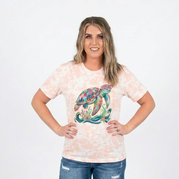 Woman wearing a tie-dye t-shirt with a colorful graphic and denim shorts on a white background