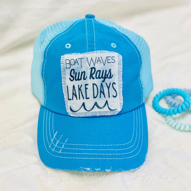 Boat Waves Sun Rays Lake Days Raggy Patchy Hat Introducing our Raggy Patch Hat, the perfect accessory for those who love a comfortable and stylish look. Made from 100% cotton, this hat ensures breathability and a soft touch against your skin, making it an ideal choice for long summer days at the lake.