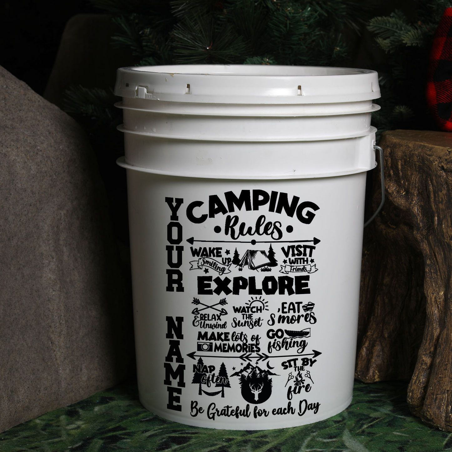 White bucket with camping-themed text and design on a natural background