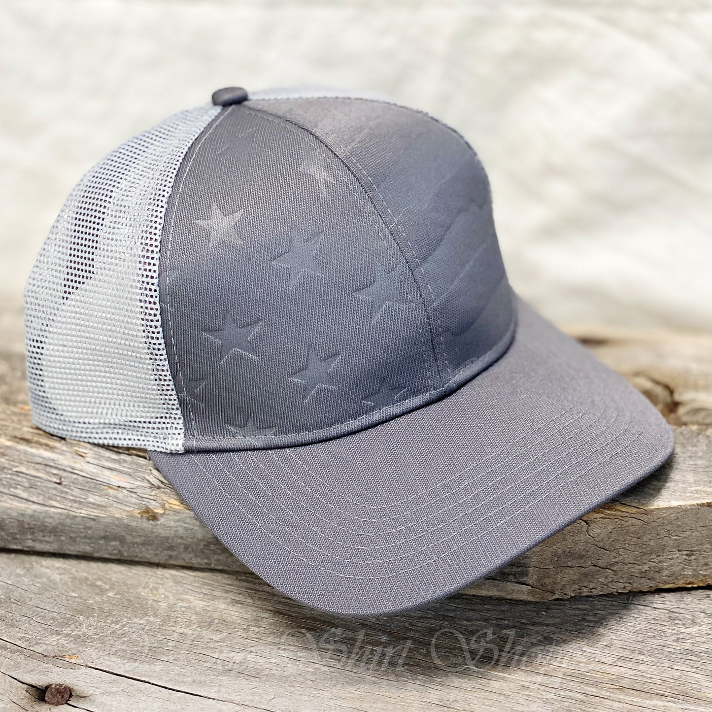Grey Debossed Stars and Stripes Mesh-Back Cap Introducing our Men's Grey Debossed Stars and Stripes Mesh-Back Cap, the perfect accessory for any stylish and patriotic man. Made from a premium blend of polyester and spandex, this cap offers exceptional comfort and durability for everyday wear.