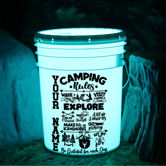 Glow-in-the-dark bucket with 'Camping Rules' text on a dark background