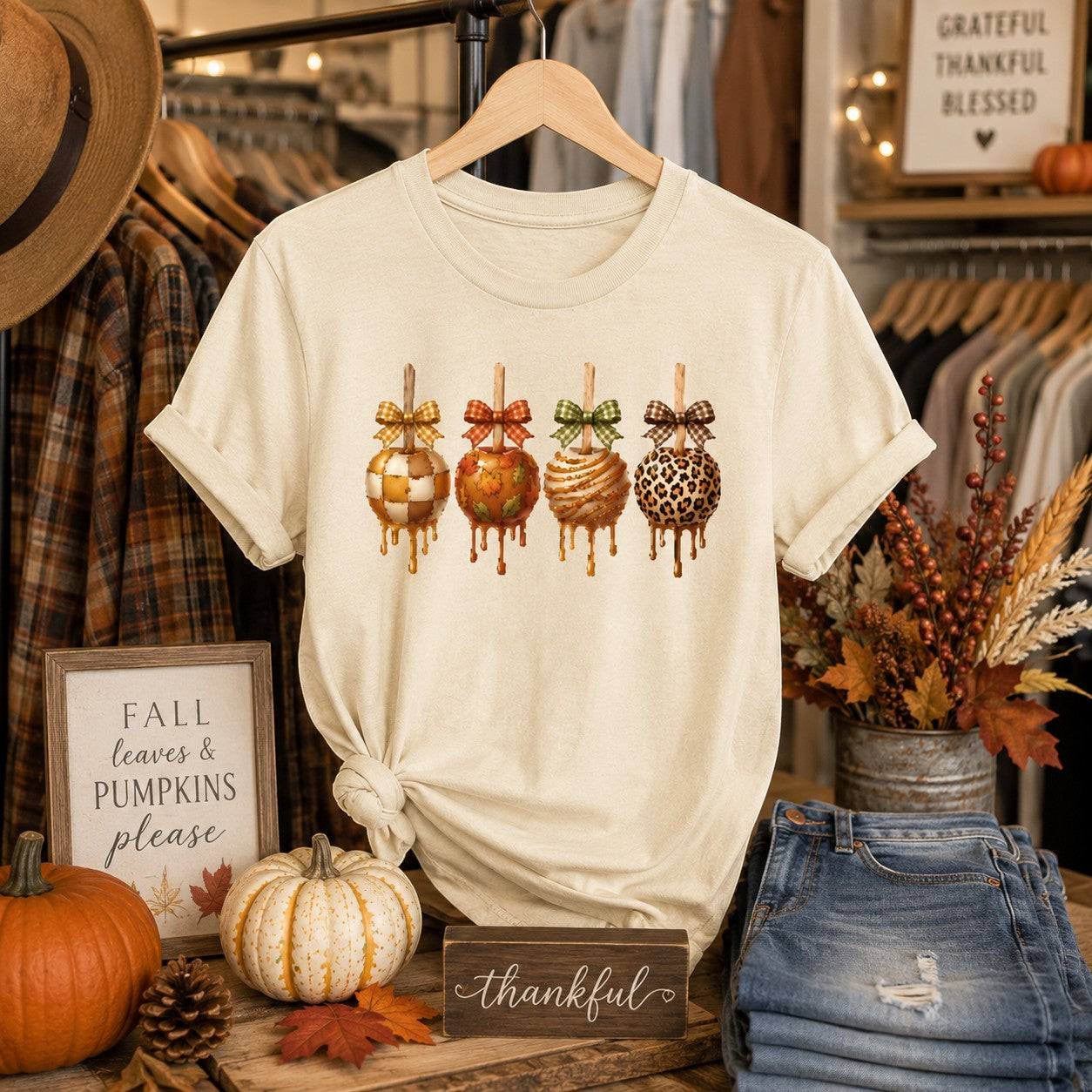 Tea-Shirt Shoppe cream graphic tee featuring four caramel apples with plaid bows, perfect for autumn fall fashion.