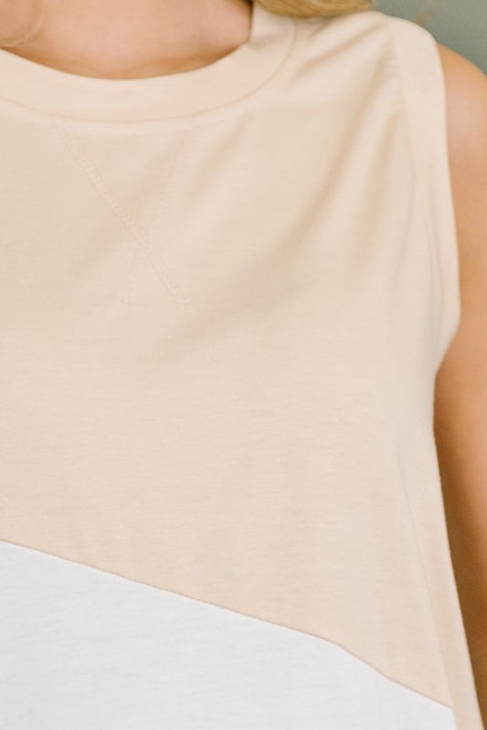 Tea-Shirt Shoppe sleeveless jersey knit top featuring a beige and white slanted color block design.