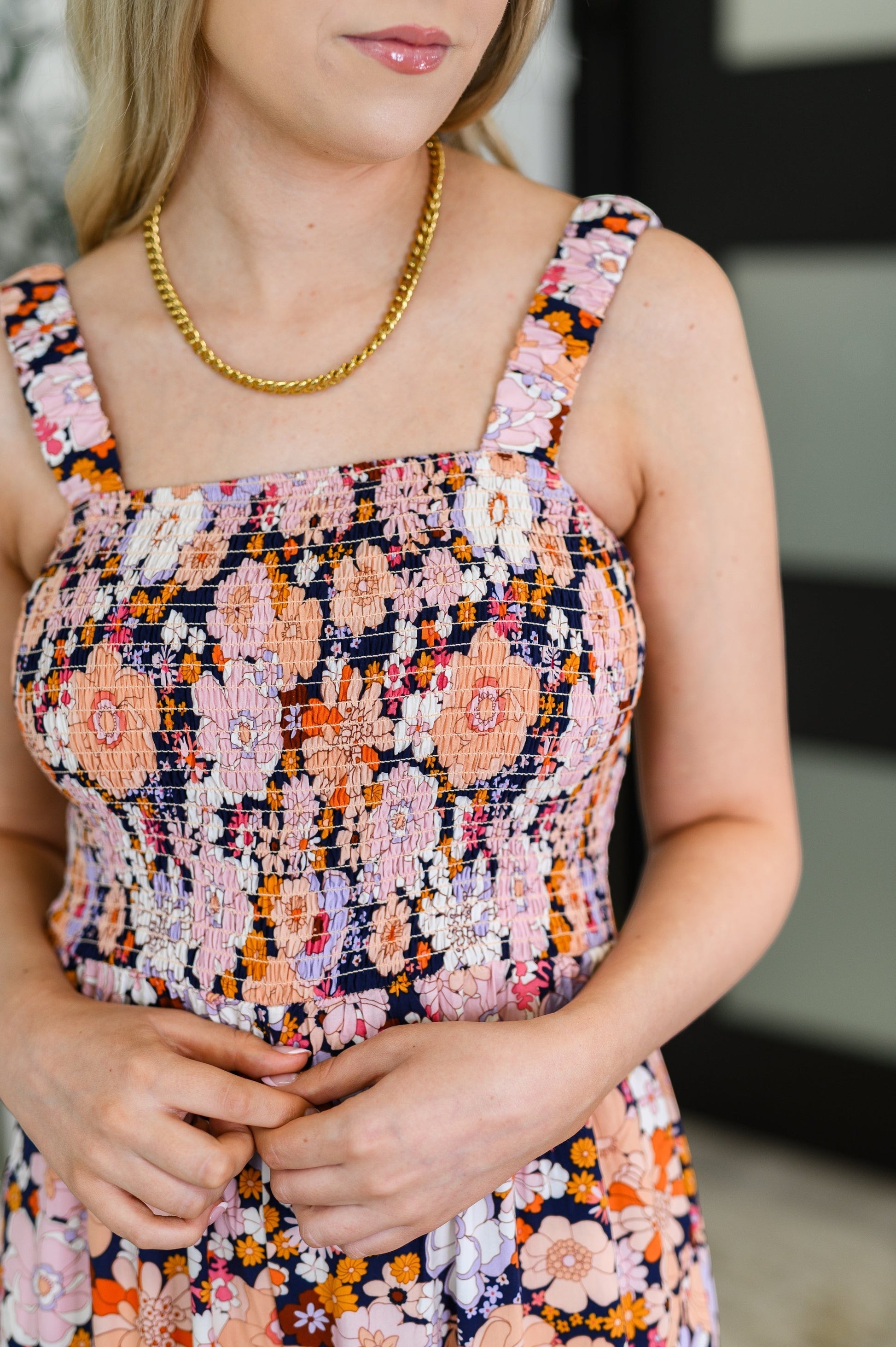 Tea-Shirt Shoppe floral jumpsuit with a smocked bodice, square neckline, and elastic straps in a retro print.