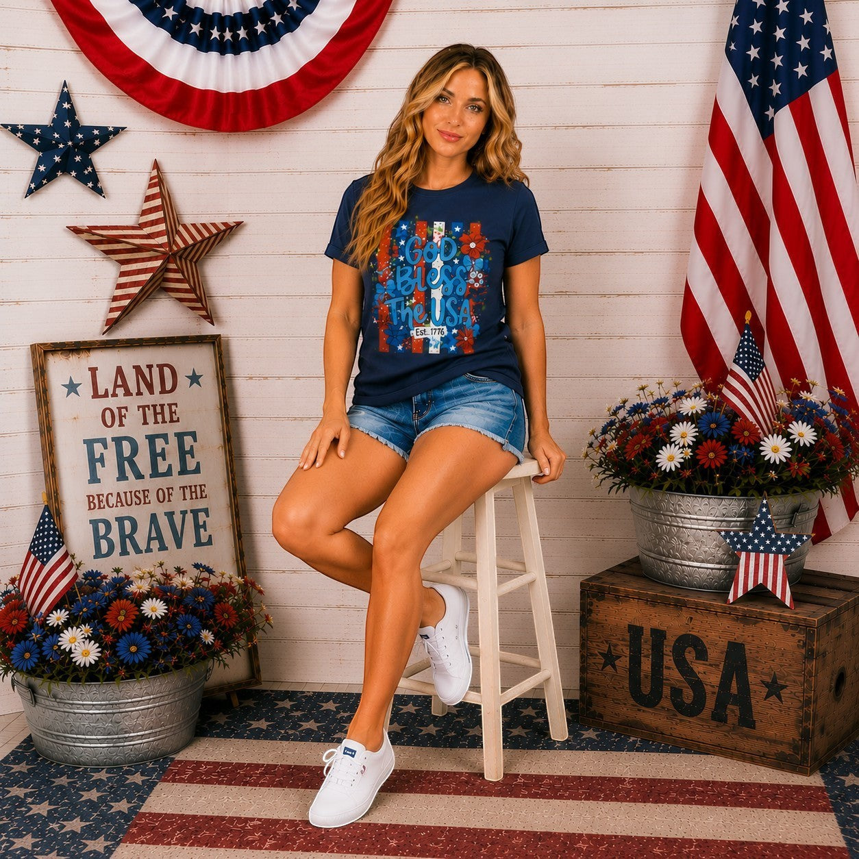 Tea-Shirt Shoppe navy blue graphic tee with "God Bless The USA" text and floral accents, Est. 1776 detail.