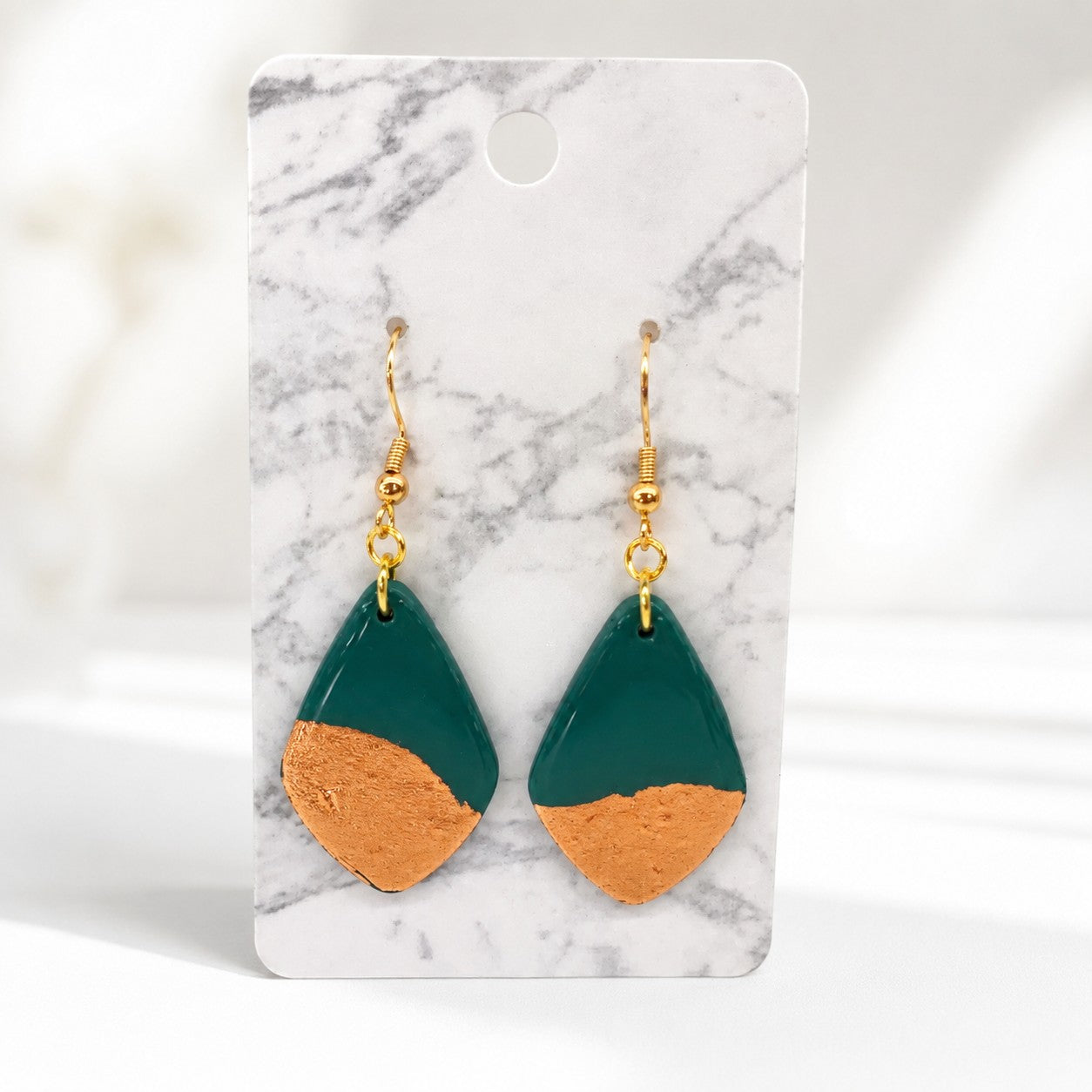 Tea-Shirt Shoppe Palm & Petal collection teardrop earrings in deep green with textured metallic gold leaf accents.