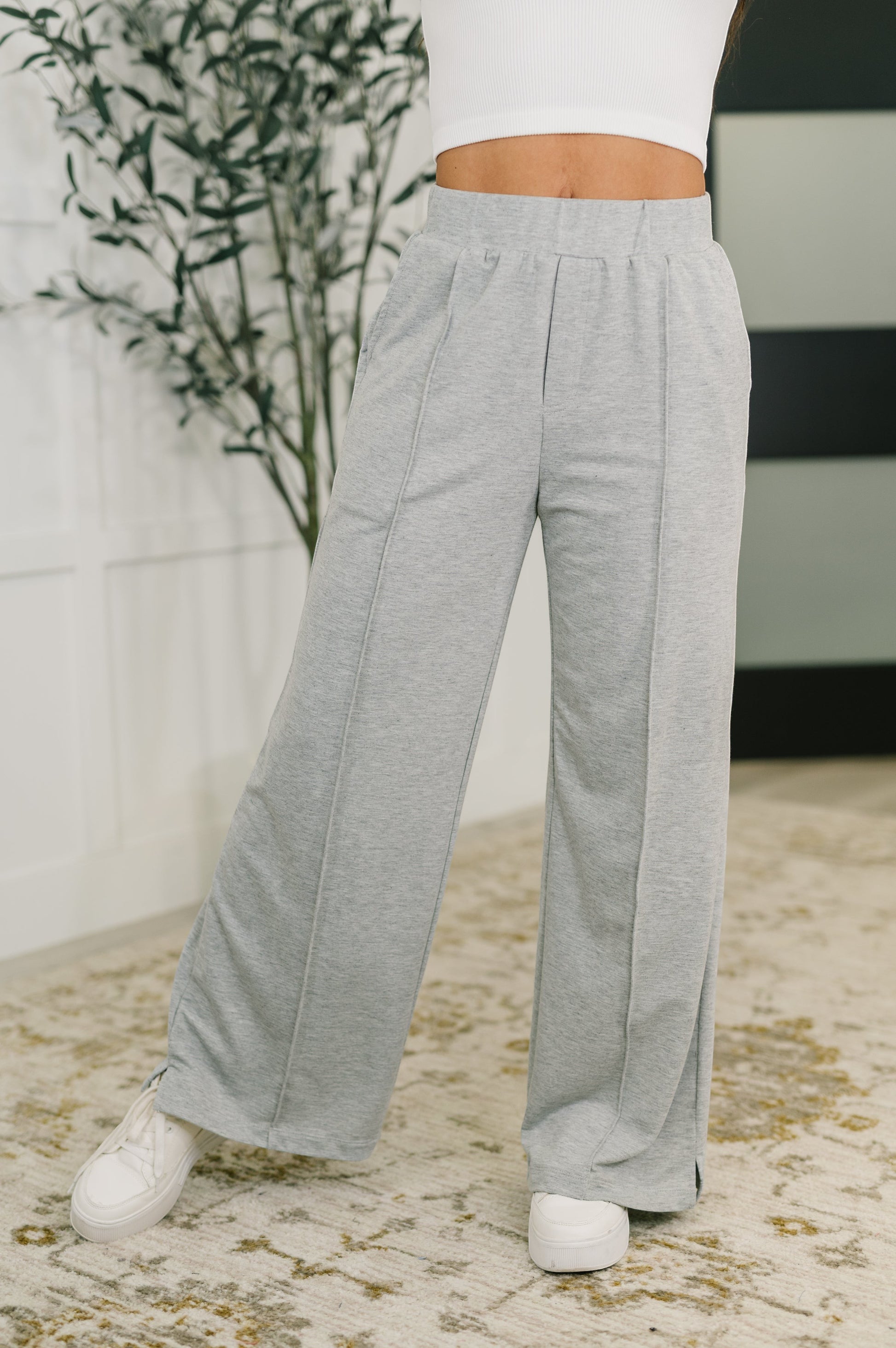 Tea-Shirt Shoppe grey knit wide leg pants with center seams, elastic waistband, and side pockets on a model.