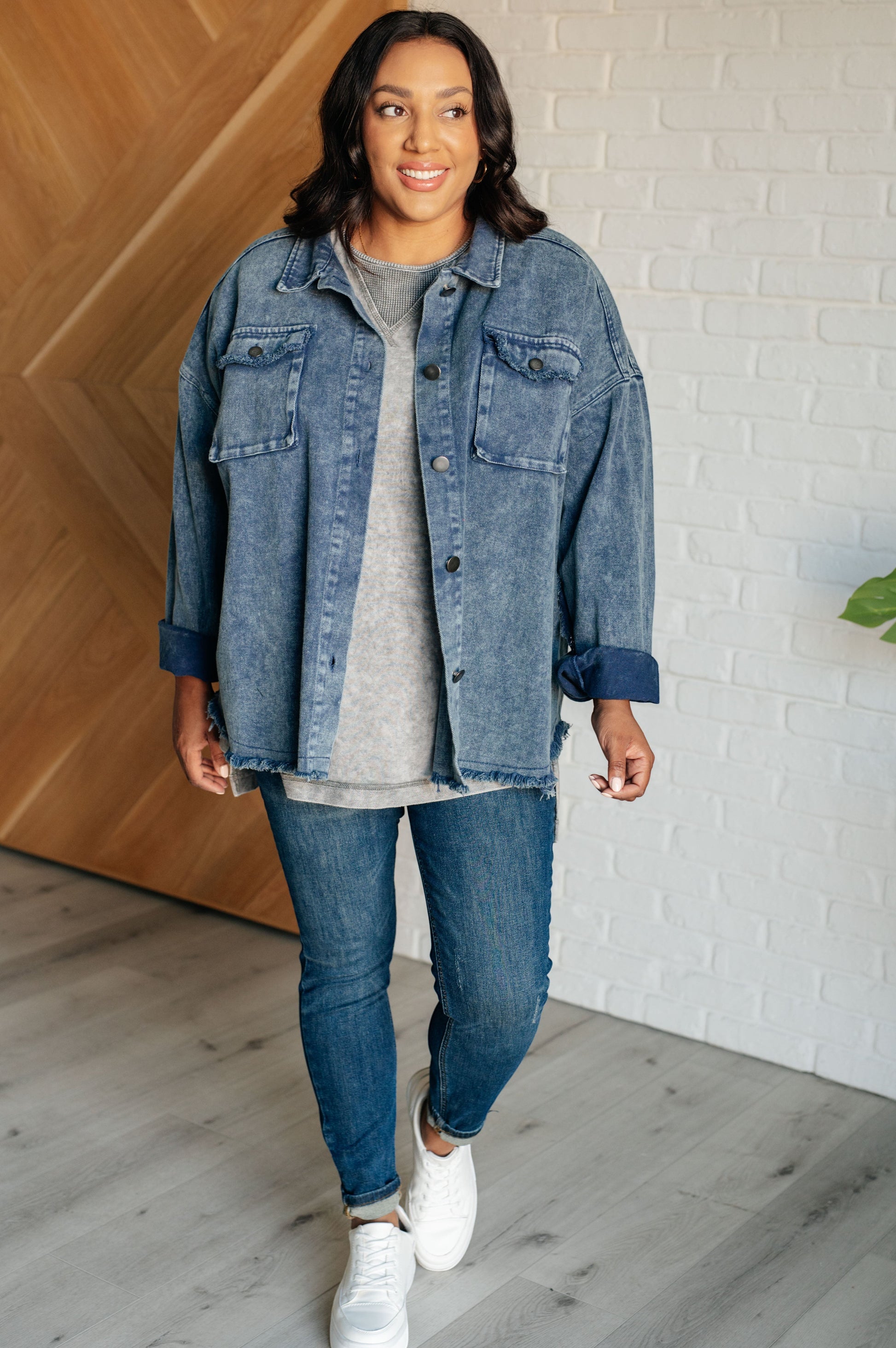 Tea-Shirt Shoppe grey mineral wash waffle knit top with drop shoulders and raw edges worn under a denim jacket.