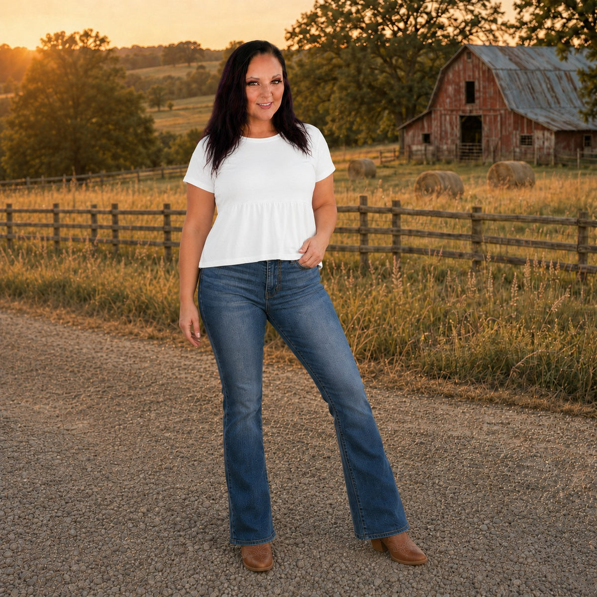 Tea-Shirt Shoppe model wearing Judy Blue dark wash high-waist bootcut jeans with tummy control in a rural setting.