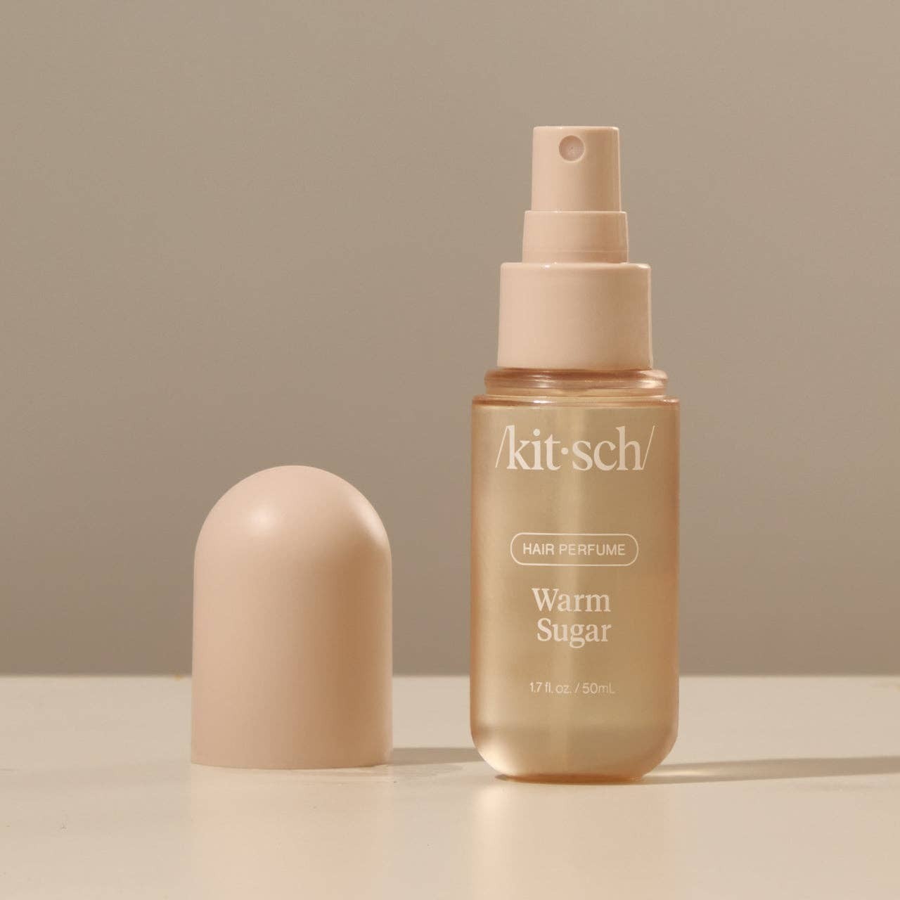 Tea-Shirt Shoppe KITSCH Warm Sugar hair and body perfume mist in a travel-sized bottle with a beige cap.