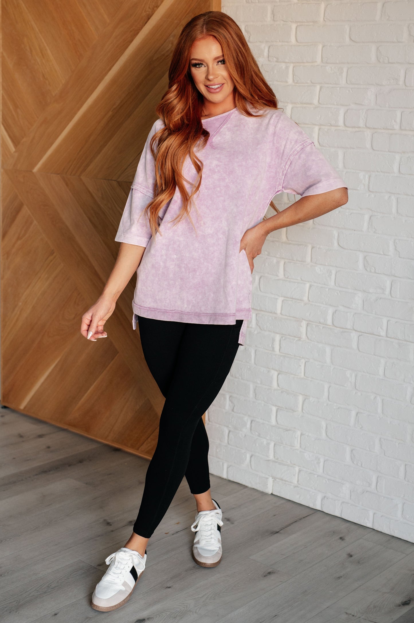 Tea-Shirt Shoppe orchid petal mineral wash top with drop shoulders, raw edges, and stepped hem worn with black leggings