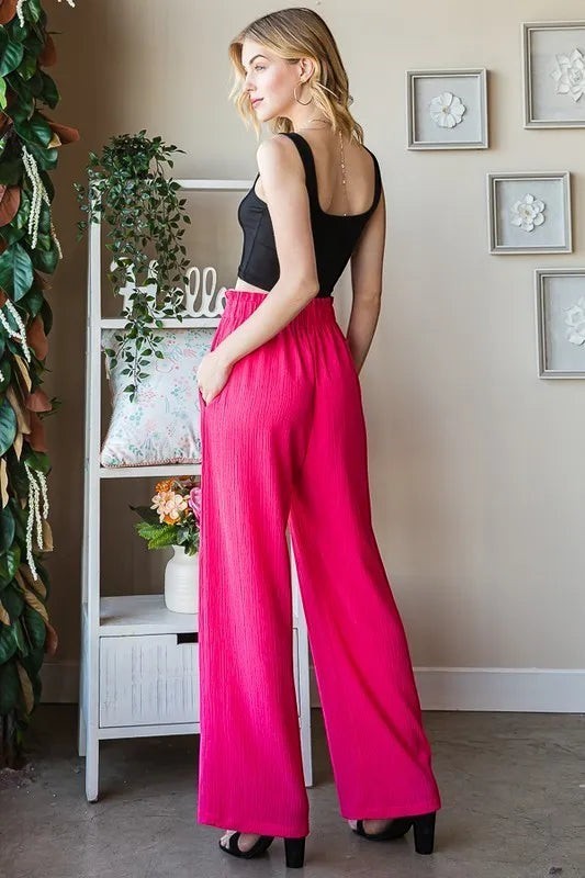 Tea-Shirt Shoppe plus size hot pink wide-leg pants with paperbag waist and side pockets, made of polyester spandex blend.