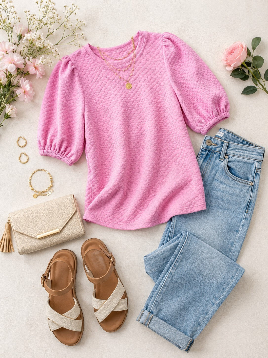 Tea-Shirt Shoppe pink textured balloon sleeve blouse styled with light wash jeans, wedge sandals, and a clutch bag.