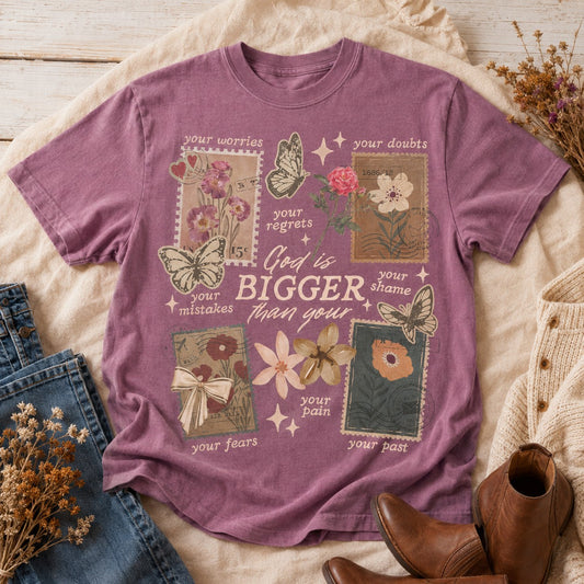Tea-Shirt Shoppe vintage-style purple cotton graphic tee with floral, butterfly, and postage stamp illustrations.