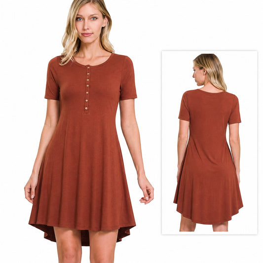 Model wearing a Tea-Shirt Shoppe rust short sleeve button-front dress with a crew neck and high-low hemline.
