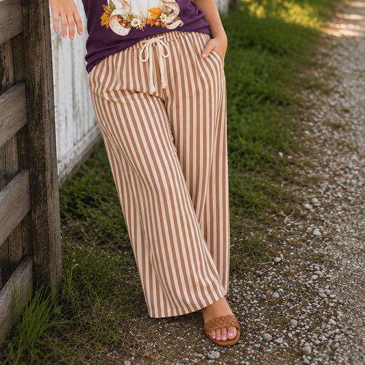 Tea-Shirt Shoppe striped wide-leg pants with an elastic drawstring waist and side pockets in neutral tones.