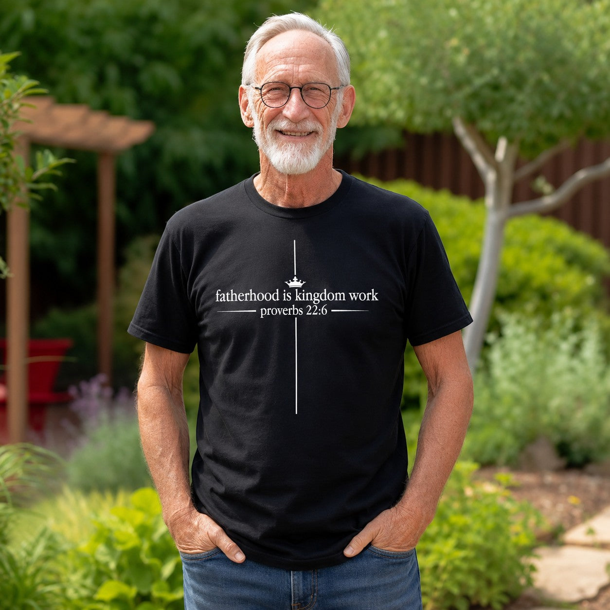 Tea Shirt Shoppe Wholesale black graphic tee with "fatherhood is kingdom work proverbs 22:6" and a cross design.
