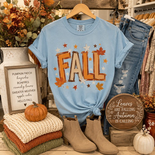 Tea Shirt Shoppe Wholesale light blue Comfort Colors t-shirt with fall watercolor graphic, styled with autumn decor.