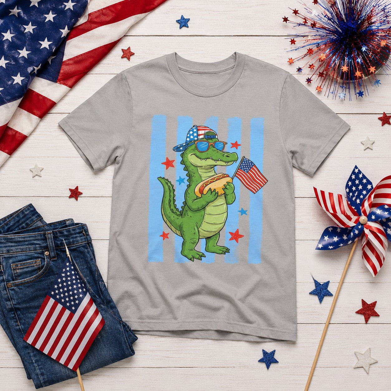 Tea Shirt Shoppe Wholesale grey 100% cotton youth graphic tee with a cartoon alligator wearing sunglasses and a hat, holding a hot dog and an American flag.