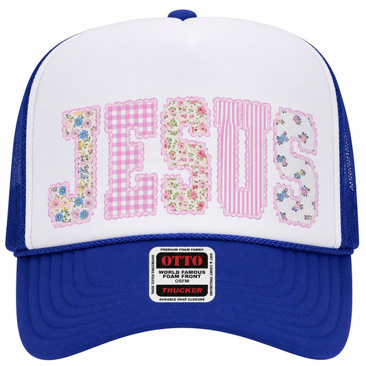 Tea Shirt Shoppe Wholesale trucker hat with white front panel featuring "JESUS" in patchwork letters, royal blue brim and mesh back.