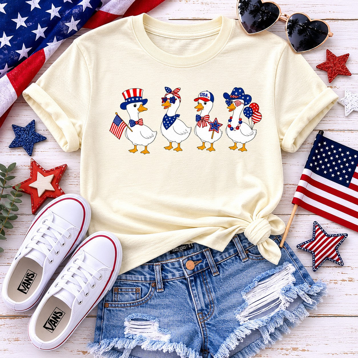 Tea Shirt Shoppe Wholesale cream graphic tee with four patriotic ducks wearing hats and holding flags. Youth and toddler sizes.