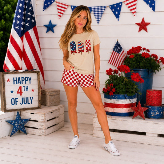 Tea Shirt Shoppe Wholesale beige graphic tee with three patriotic popsicles. Features red, white, and blue designs.