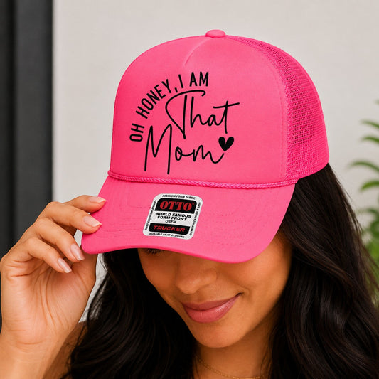 Tea Shirt Shoppe Wholesale bright pink trucker hat with "Oh Honey, I am That Mom" graphic and mesh back.