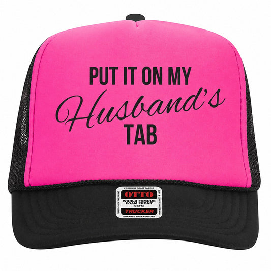 Tea Shirt Shoppe Wholesale neon pink foam trucker hat with black mesh back and Put It On My Husbands Tab graphic.