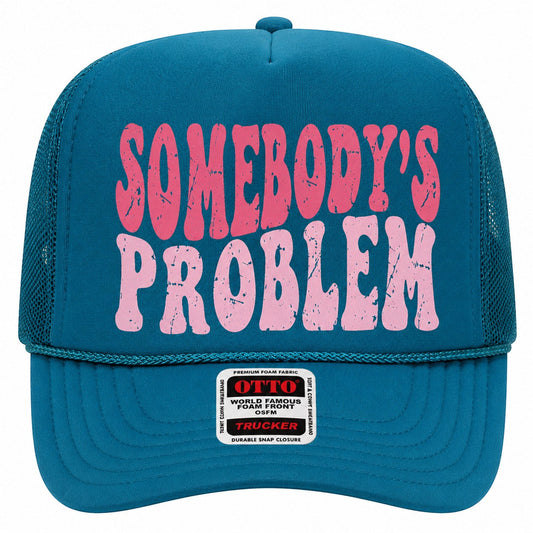 Tea Shirt Shoppe Wholesale teal trucker hat with pink distressed Somebody's Problem graphic and mesh back.