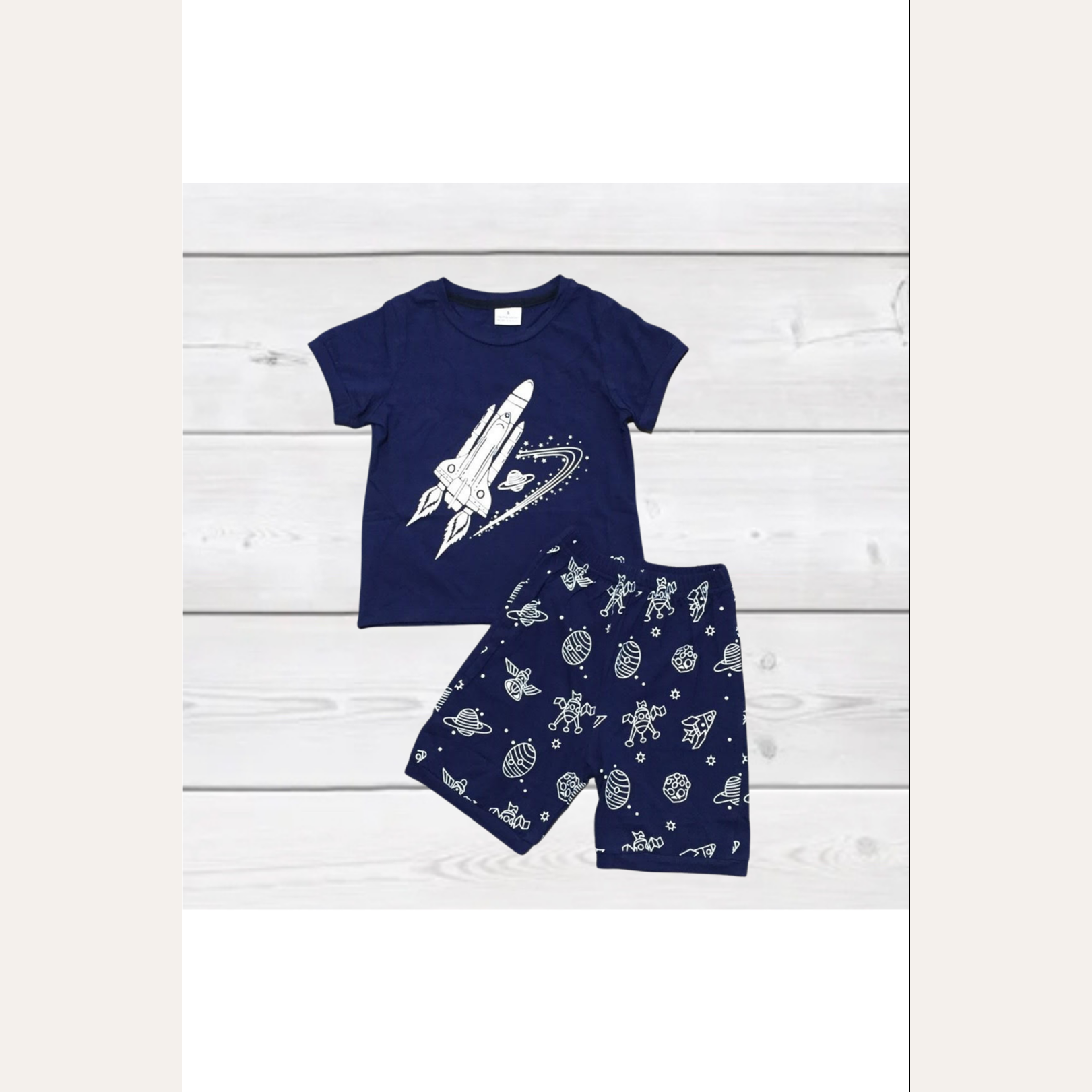 Blast off in this adorable navy and white short set! Features a white rocket shooting across and navy background graphic tee and matching shorts!  IN-STORE!