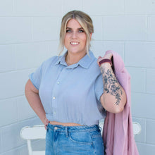 A new twist to a button up shirt. This shirt is so unique how it was made and im in love with it. pair it with our Tori straight leg jeans and any of our hollys.  woven shirt with the following features: Collared neckline.Short puff sleeves. Button-front closure. Elastic back waist. Front wrapped hem design. Cropped length.   Size up if you are blessed with a chest i sized up 1 and it fit me perfectly If you dont have a big chest though it will fit you perfect.