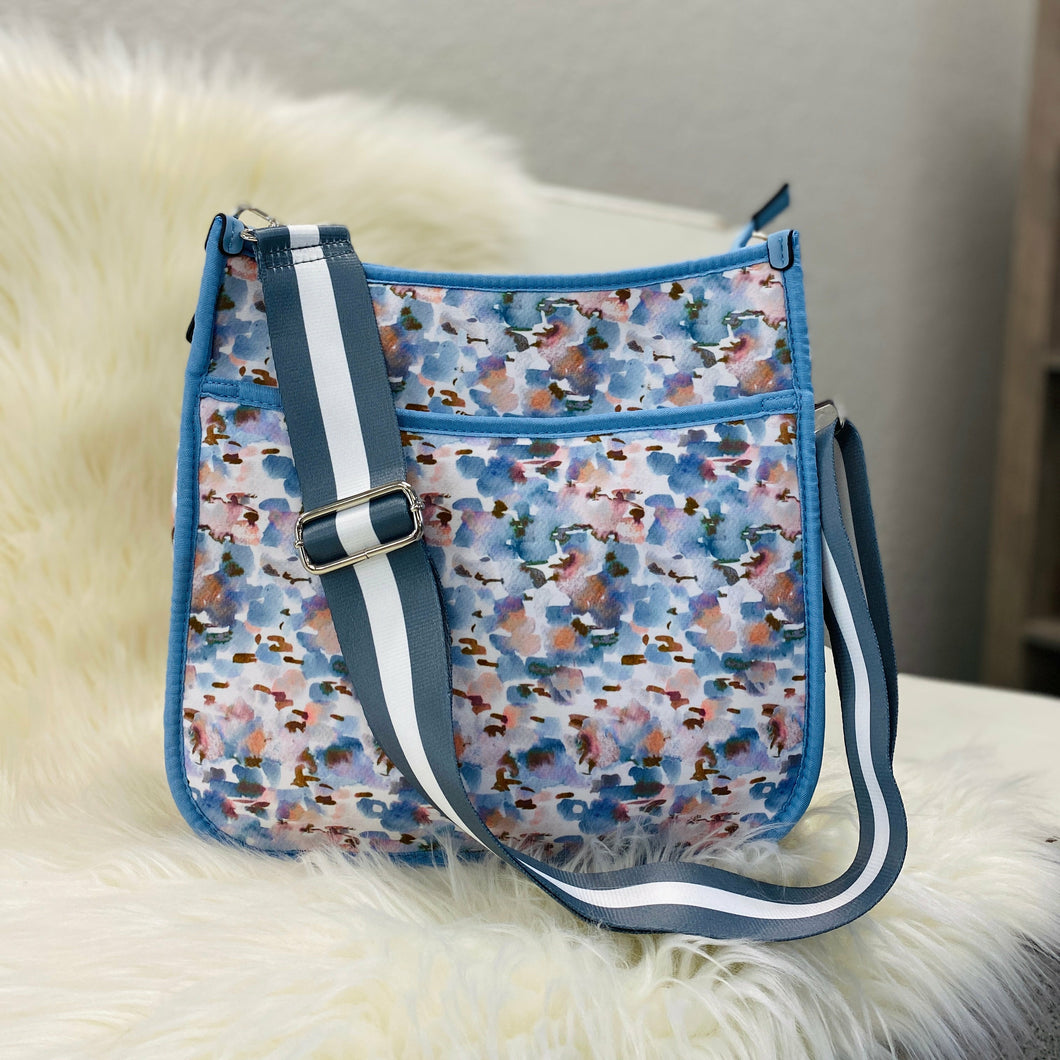 Printed neoprene crossbody Front slip pocket Back zip pocket Adjustable/removable guitar strap Strap is approximately 29