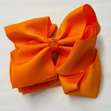 Orange grosgrain bow.