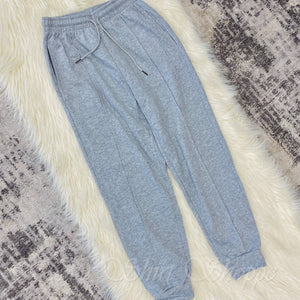 Introducing our new Heather Grey Tapered Lounge Pants! This lounge wear staple comes in a trendy tapered style with cuffed hem and drawstring waist, meant to give you an effortlessly stylish and comfortable look. 