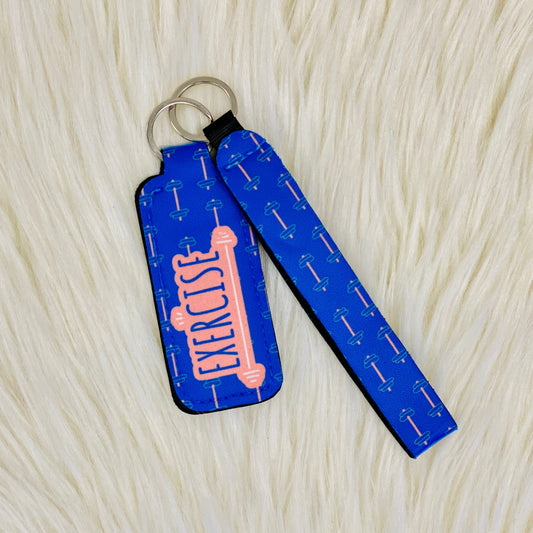 Blue Exercise Lipbalm Holder & Keychain Our gym themed Lipbalm Holder & Keychain is not just a cute gift for her, it is also practical. It has a lipbalm holder and a keychain so you can attach it to your purse, backpack or keys, and then you never have to worry about misplacing it. The exercise lipbalm holder is the perfect stocking stuffer for women of all ages.  Gym theme Keychain measurements: 5" Lipbalm holder measurements: 3.75"x1.5"