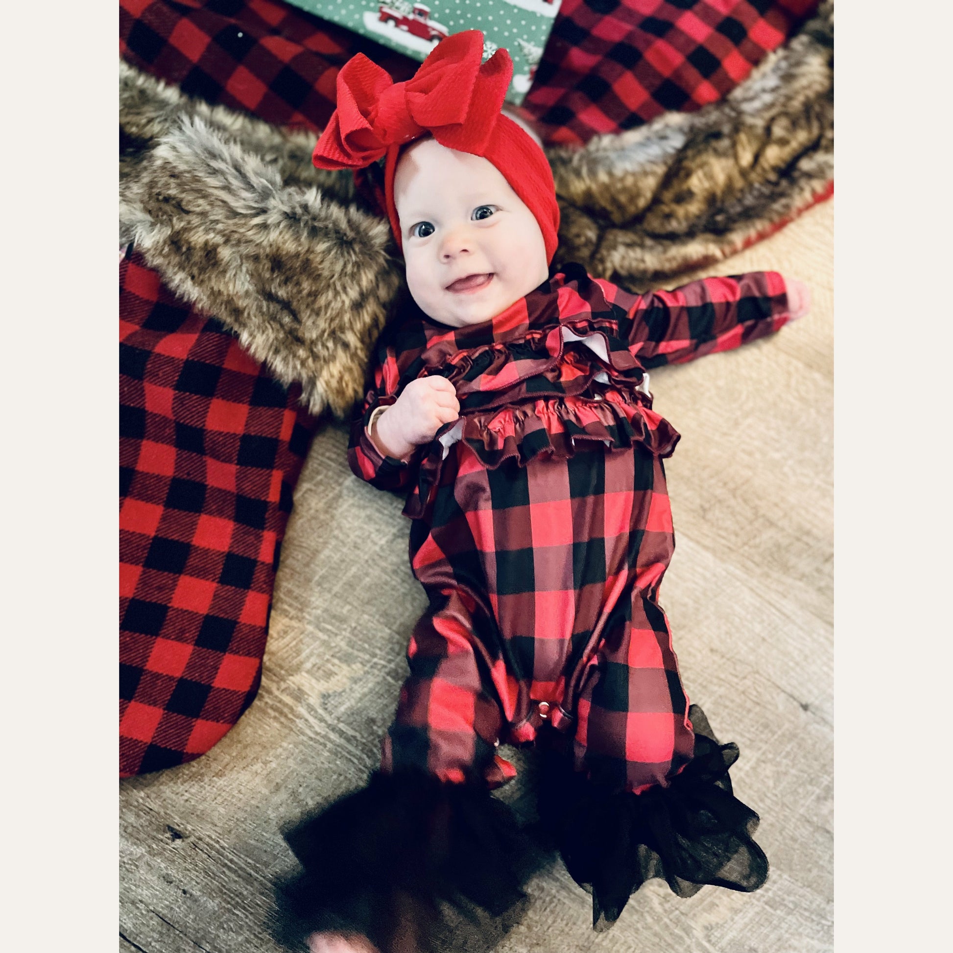                                        Ruffle Buffalo Plaid Romper  You can never have too much buffalo plaid! This romper is extra cute with the ruffles on the body and tulle ruffles at the feet!   Fits true to size. Polyester.
