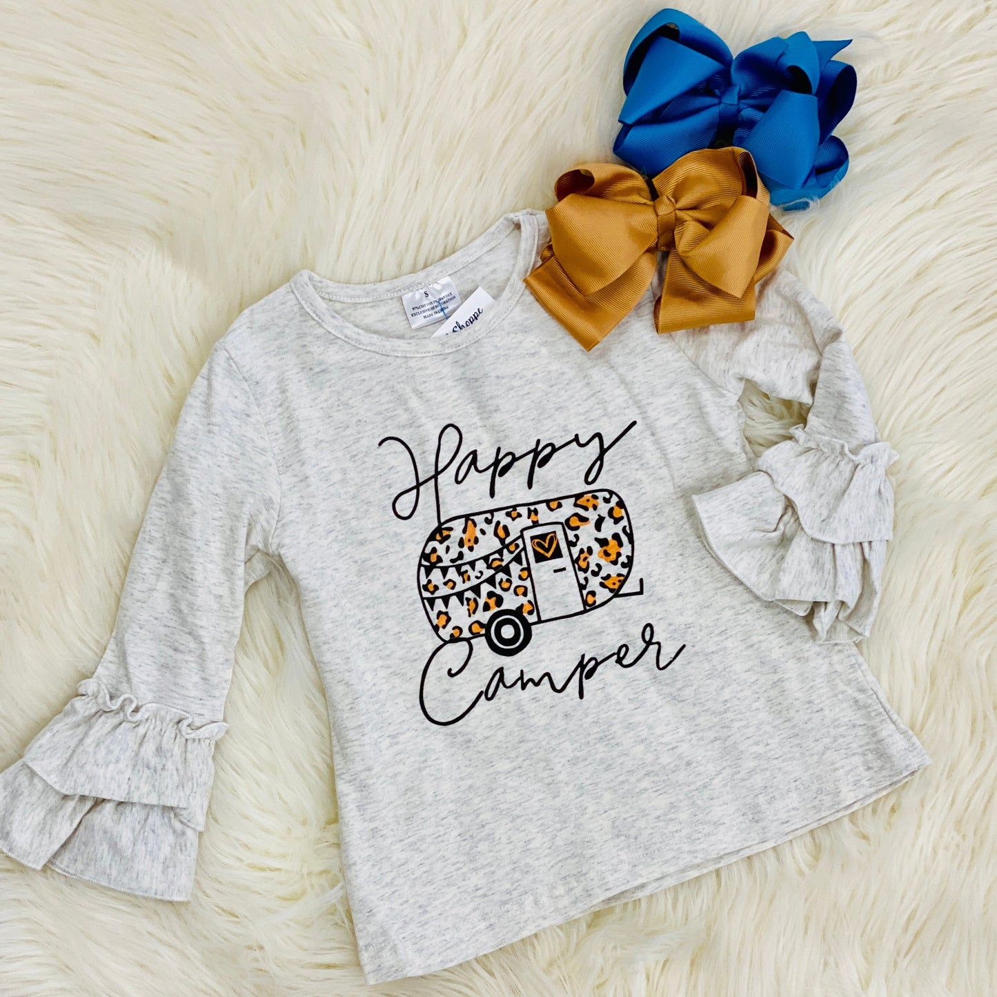 This heather gray fall graphic ruffle sleeve top features a vibrant leopard camper design and flared ruffle sleeves. We recommend pairing it with our leopard patch jeans.  In-store ready to ship or try on!